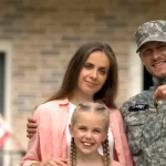 A veteran takes a photo with his family in Houston