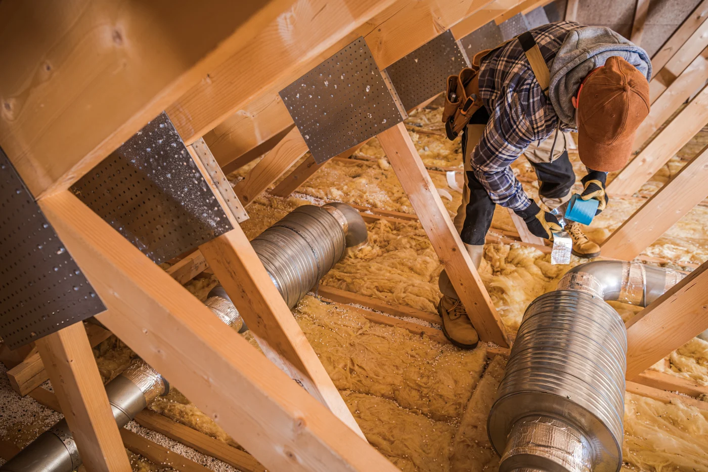 Technician applying attic insulation in a Pasadena home