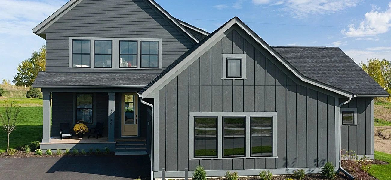 Modern home with grey lp smartside siding and a black roof