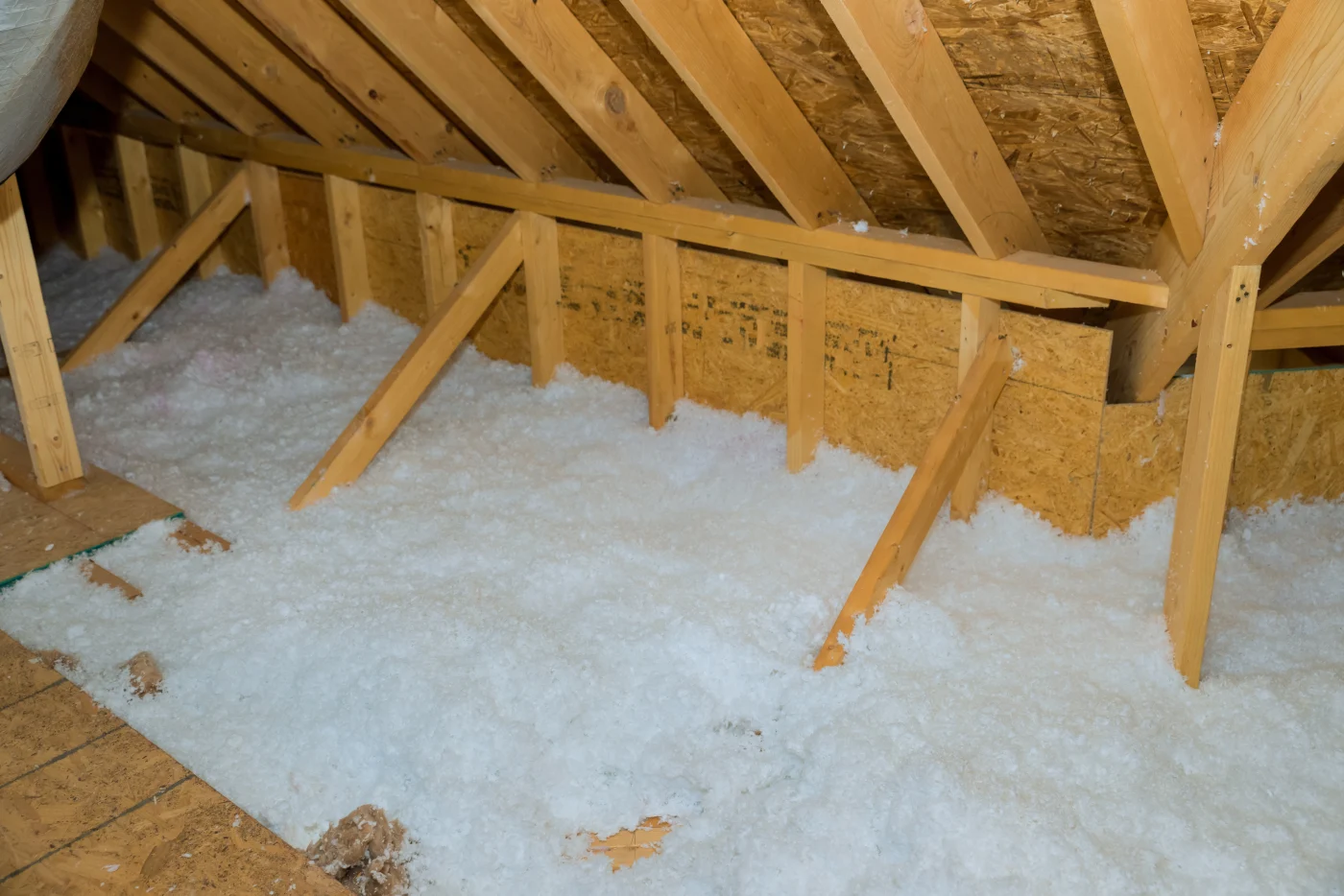 Blown in insulation in home attic to increase energy efficiency