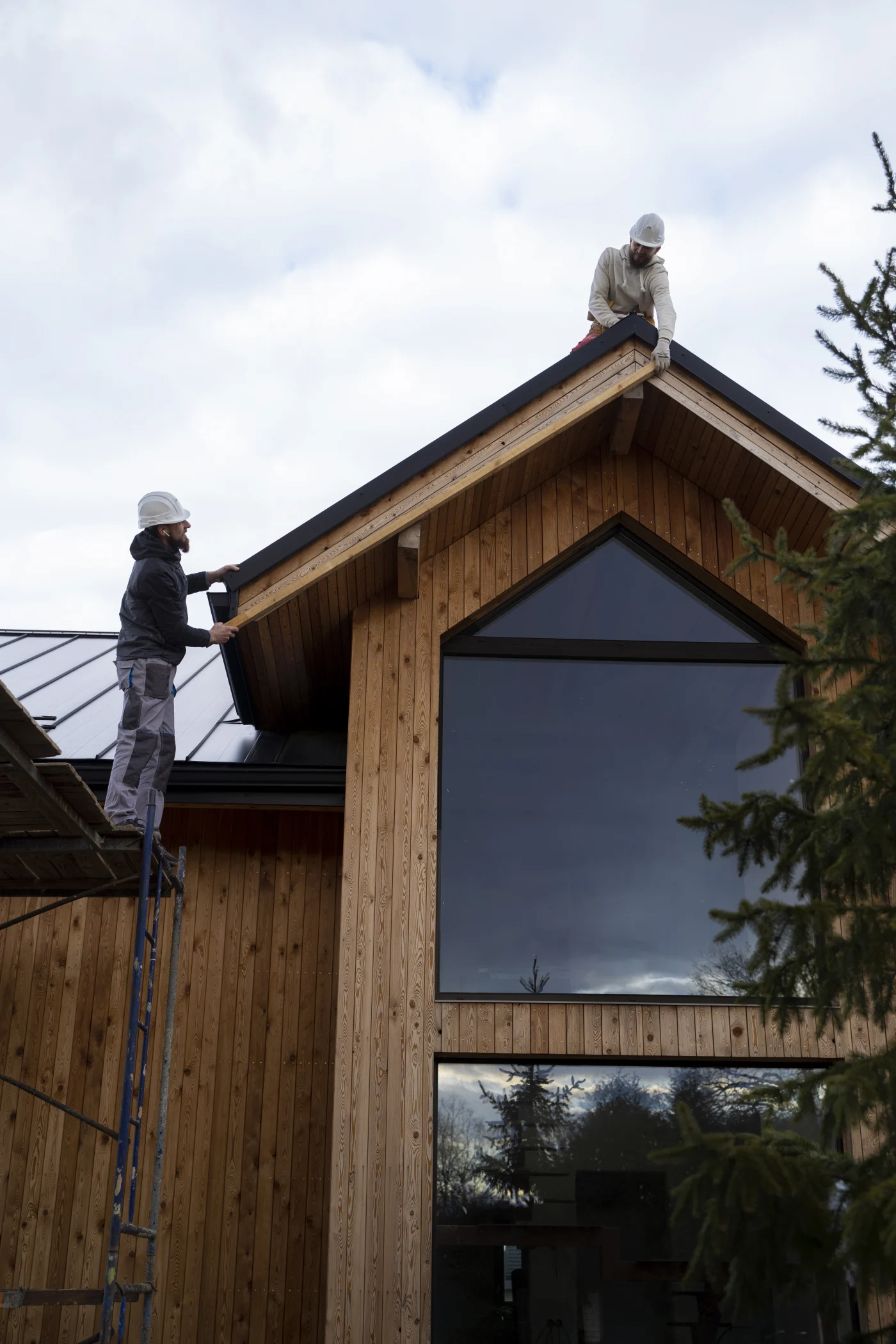 An aerial view of a black shingled roof on a beautiful new home build