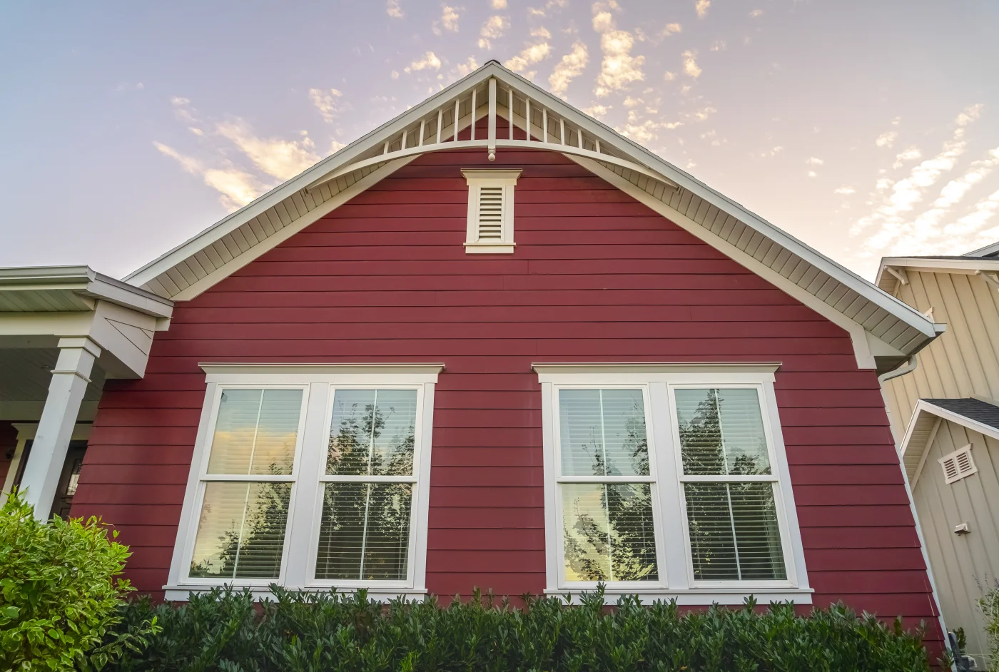 Up close view of red siding on the facade of home
