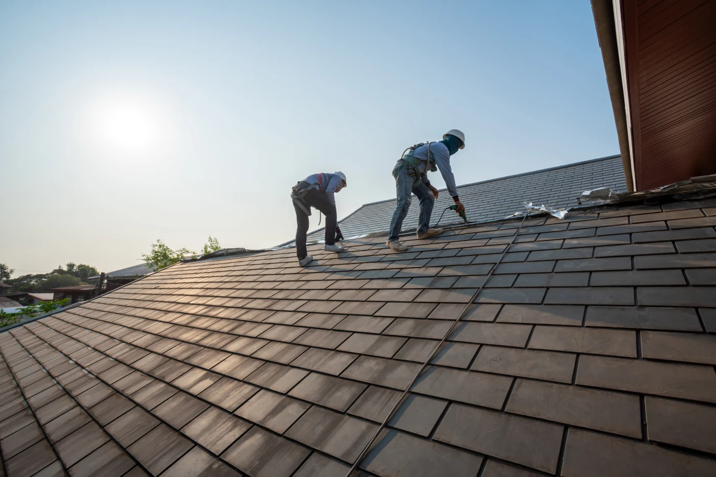 Proper roofers repairing a home's roof