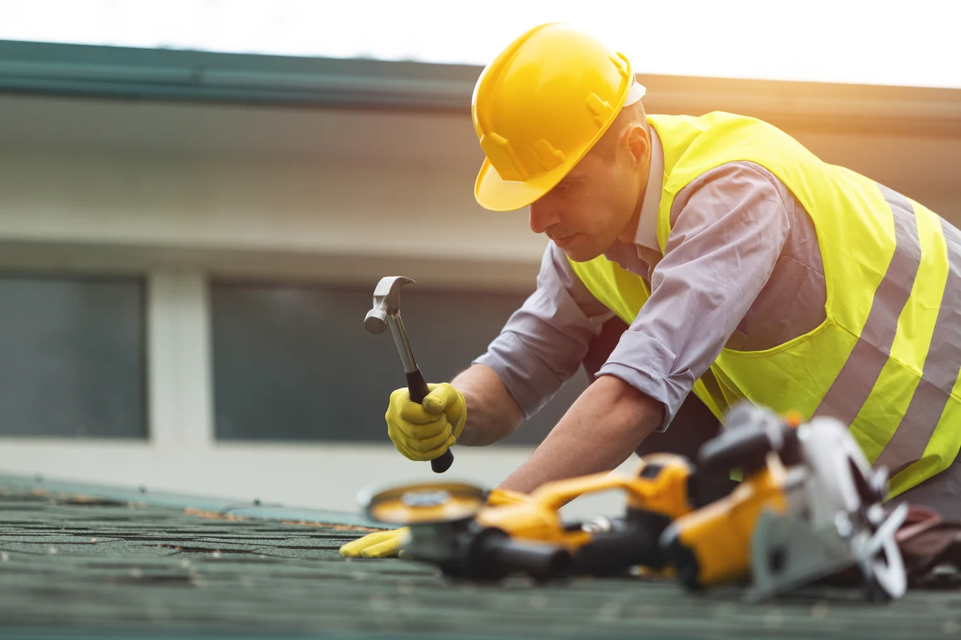 Proper Roofing specialist works on residential roof