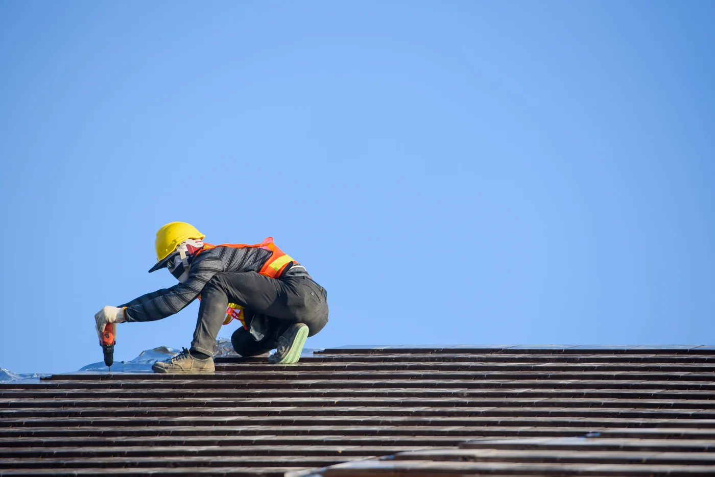 A Proper Roofing roofer repairs a residential roof