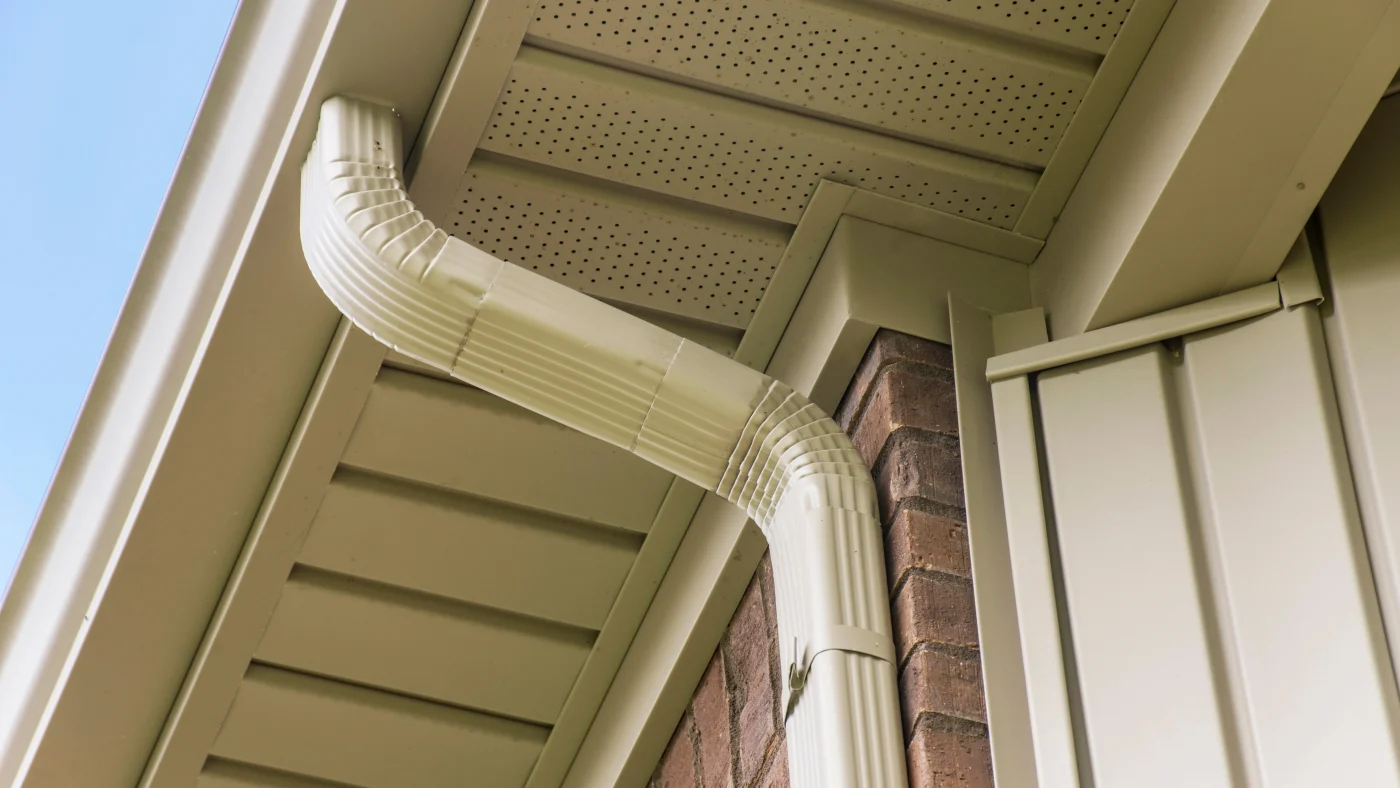 White seamless gutters above a white soffit