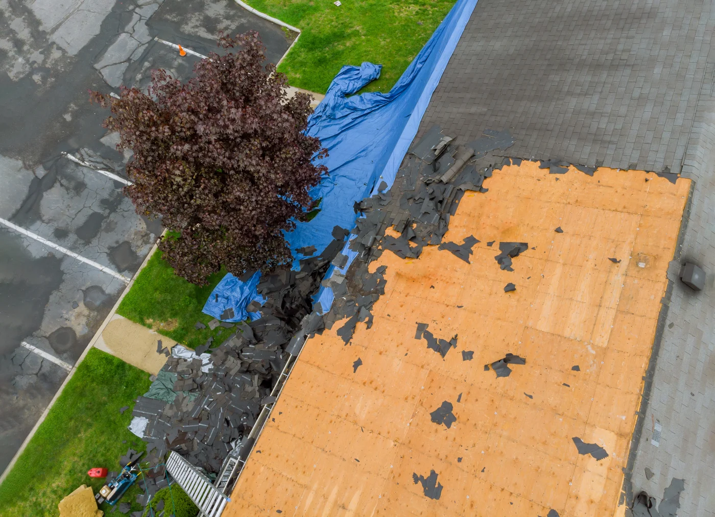 Storm-damaged shingles under repair