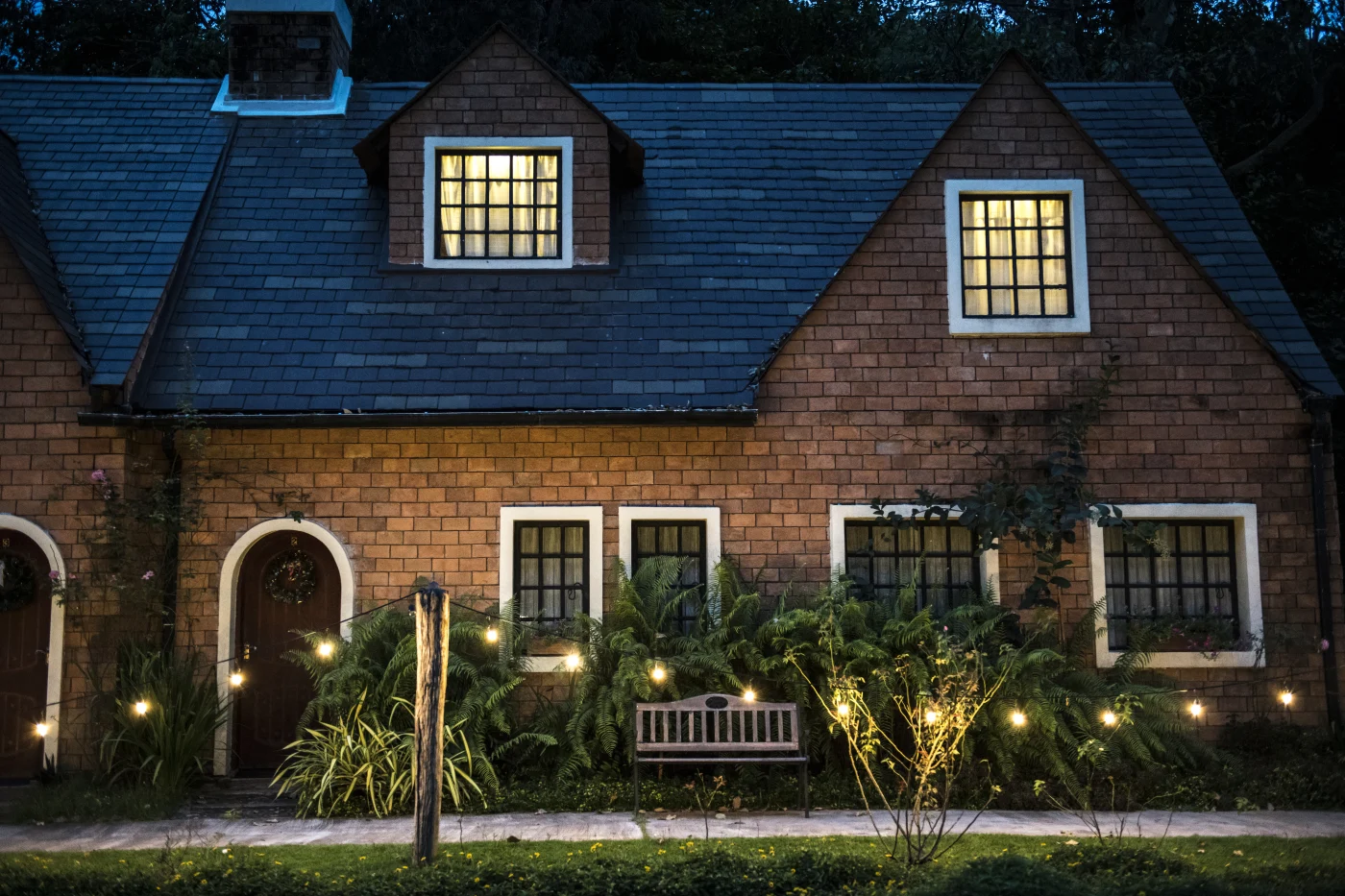 Nice brick home with dark shingles roofing